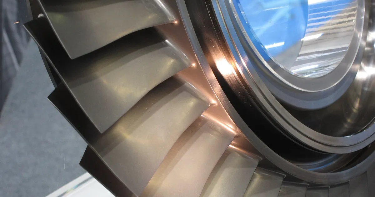 Close view of a compressor blisk on display, a disc with its blades machined as one piece, the kind of part made by 5-axis machining