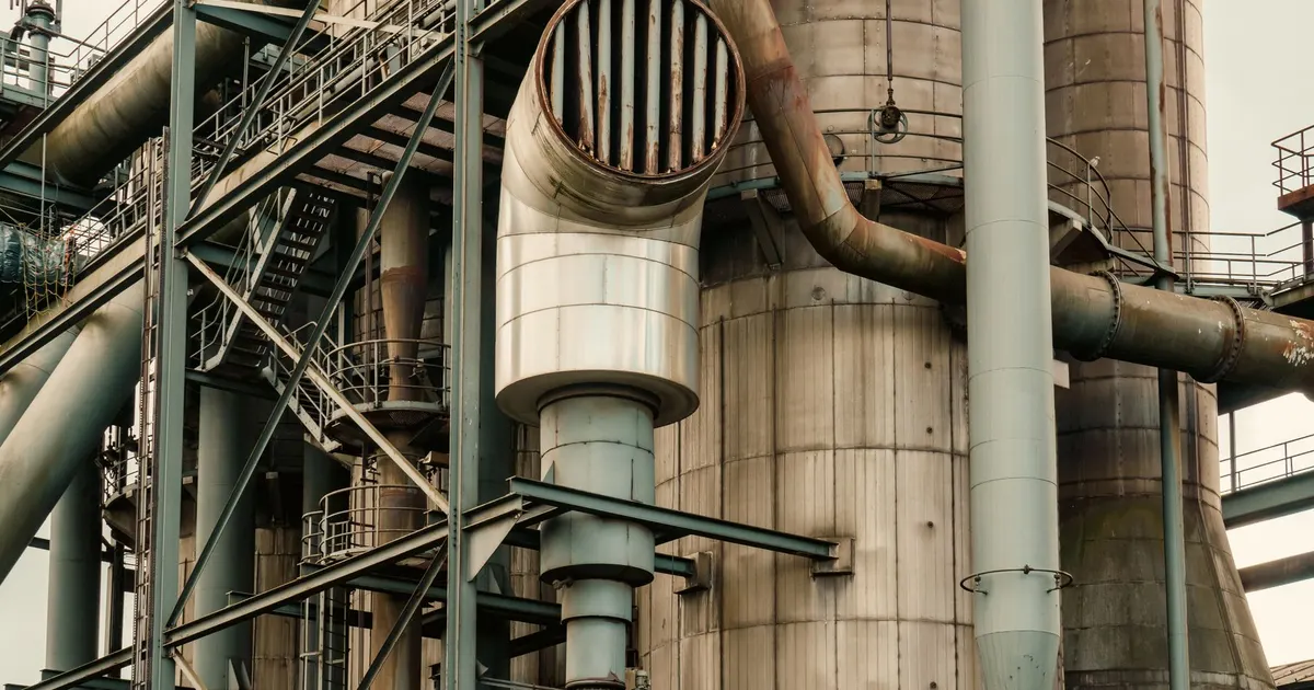 Industrial plant with large vessels and piping, a generic view of the type of chemical process equipment where corrosion-resistant nickel alloys are used