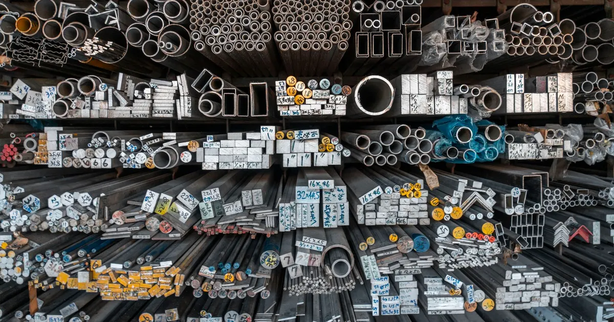 Warehouse racks holding metal bars, tubes and sections of many sizes, a generic view of stocked bar material